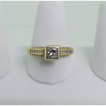 A single stone diamond Ring, the princess cut stone approx 0.5ct, collet set above an 18ct yellow