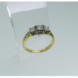 A graduated three stone diamond Ring, the central princess cut stone approx 0.35ct (3.85mm wide)