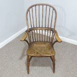 An antique ash and elm Windsor Chair, with stick back and shaped seat, on turned legs joined by H