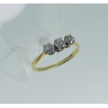 A three stone diamond Ring, the centre circular stone approx. 0.22ct, the outer stones approx 0.