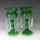 A pair of Victorian green glass Table Lustres, with etched decoration and clear glass drops, drops
