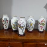 Three Franklin Porcelain baluster shaped vases on wooden stands, decorated with garden birds,