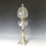 A Victorian silver plated column Oil Lamp, having an etched clear glass shade and cut glass font,