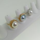 An 18ct gold Dress Ring, the centre with a mabé pearl in textured setting, now loose, the pearl