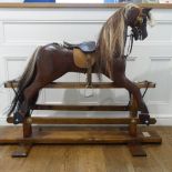 A good quality modern wooden Rocking Horse, with real horse hair mane and tail and leather saddle