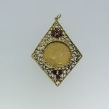 A Victorian gold Sovereign, dated 1871, in a 9ct pierced and textured mount set garnets, 5.5cm long,