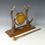 An early 20thC antler mounted Dinner Gong, raised on oak base with brass mounts, W 38cm x D 14cm x H