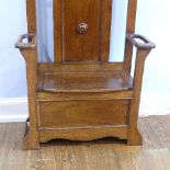 An early 20thC oak Hallstand, with central bevelled mirror, hinged box seat and two drip trays, W