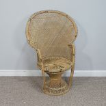 A 1970s rattan Peacock Chair, with woven twist base, W 87cm x D 50cm x H 115cm.