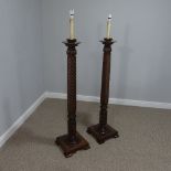A pair of mahogany Torchere Standard Lamps, with carved and spiral turned columns, raised on a