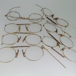 A collection of seven gold plated Pince Nez, together with a damaged 18ct gold stick pin, 1.2g (8)