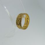 An 18ct yellow gold Band, hallmarked London 1978, with foliate decoration, 6.9mm wide, Size O,