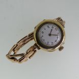 A 9ct gold lady's Wristwatch, the white enamel dial with Arabic numerals, Swiss 15 jewels