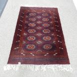 Tribal rugs; a dark red ground hand-knotted Turkomen rug, wool pile on cotton base, L 192cm x W