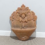 Garden Statuary; a vintage terracotta wall Fountain, moulded in relief with a classical bust, the