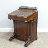 A Victorian walnut Davenport, the rectangular top with galleried stationery compartment, lifting