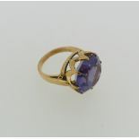 A synthetic colour change sapphire dress Ring, the circular facetted stone approx. 15mm diameter,