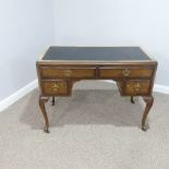 An early 20thC walnut Writing Desk, with rectangular top having inset writing skiver, above four