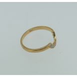 An 18ct yellow gold and diamond Ring, the U shaped front set with ten small circular diamonds,