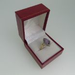 An amethyst Dress Ring, the navette shaped facetted amethyst vertically set within a surround of