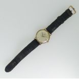 A 9ct gold Omega Automatic gentleman's Wristwatch, the silvered dial with gilt baton markers and