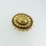 A Victorian Target Brooch, with box and glass reverse, 3.5cm long, tests as 15ct gold, 6.5g with box