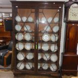 An early 20th century mahogany astragal glazed Bookcase, with blind fretwork and a glazed door