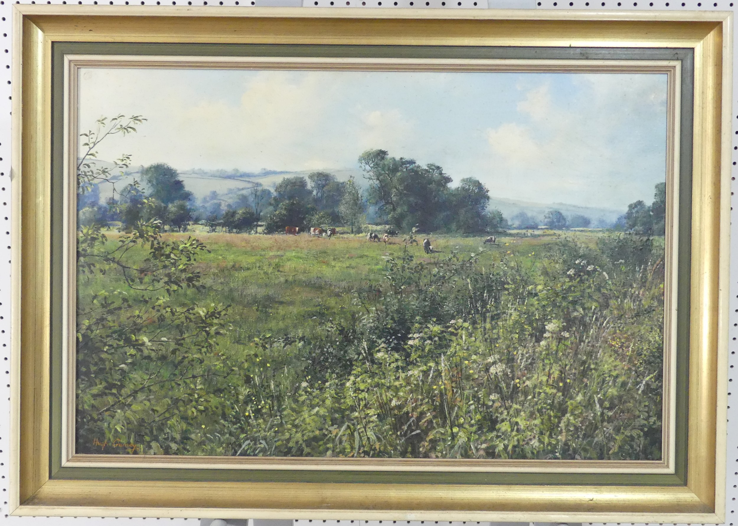 Hugh Gurney (British, b.1932), Cattle grazing in a wooded landscape, oil on board, signed lower