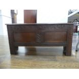 A small early 18th century oak Coffer, the two-panel front with carved decoration, on high stile