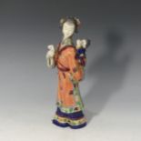 A 20thC Chinese porcelain Figure of a mother and child, decorated in rich enamels, with character