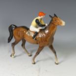 A Beswick pottery Horse and Jockey, with yellow and black silks, red cap and no. 24 on