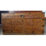A 20thC Oriental carved camphorwood Chest, the hinged lid carved with oriental figures in a