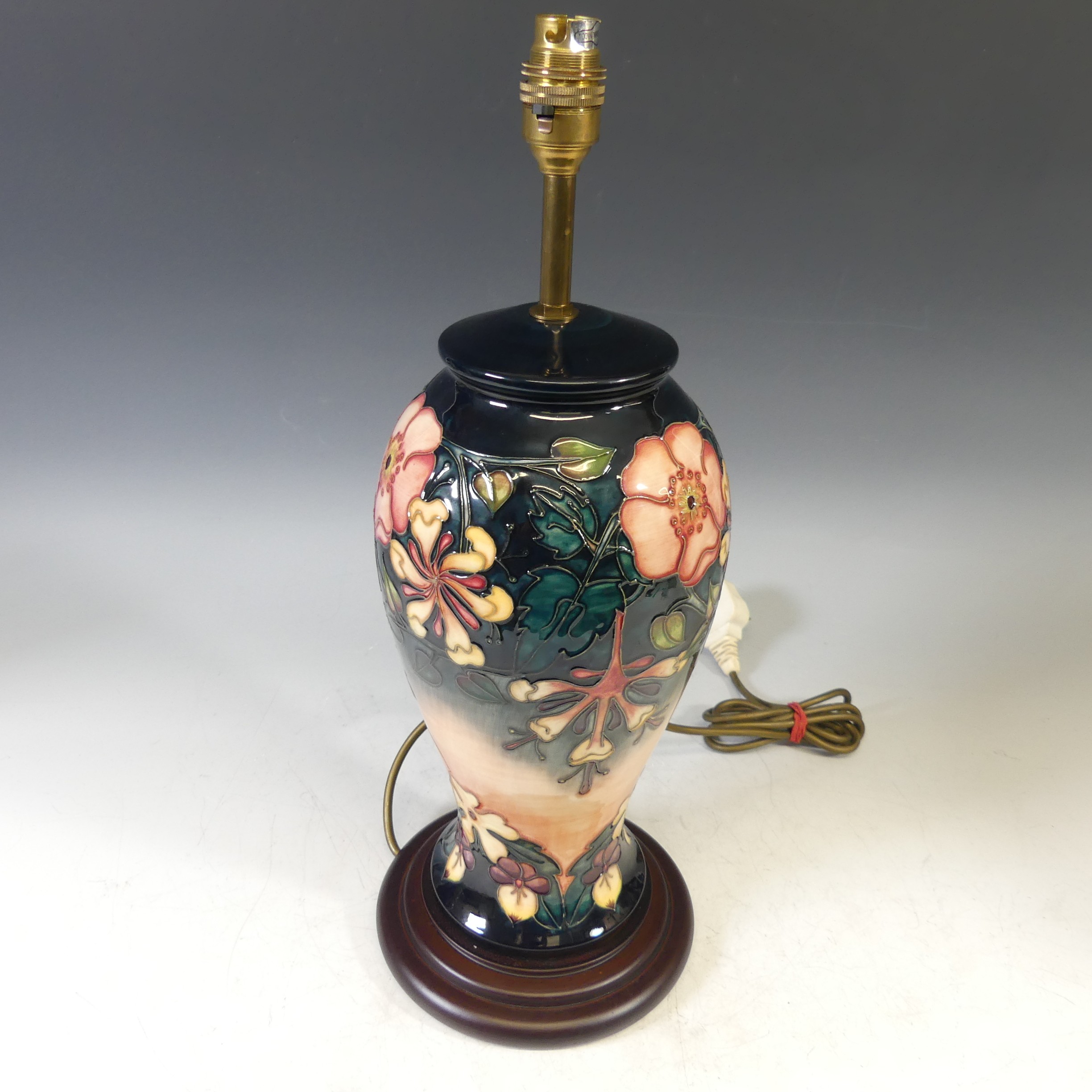 A Moorcroft 'Oberon Honeysuckle' pattern Table Lamp, with tubelined decoration on a blue and