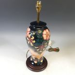 A Moorcroft 'Oberon Honeysuckle' pattern Table Lamp, with tubelined decoration on a blue and