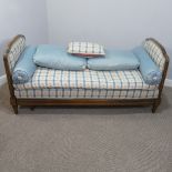 An early 20thC French Day Bed, with extendable carved walnut show frame, upholstered seat and