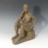 A studio pottery female nude by Paul Redvers, ex Honiton pottery, depicting a seated female in a