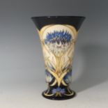 A limited edition Moorcroft 'Cornflower Cavalcade' pattern Vase, with stylised flowers on a blue and