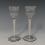 A pair of Georgian twist stem Wine Glasses, the ogee bowl etched with grapes and vines, one with