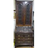 An antique oak Bureau Bookcase, with later carved decoration, with alterations, lacks full