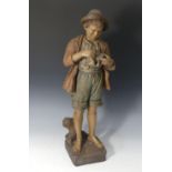 A Goldscheider Wien painted terracotta Figure of a Young Boy, modelled holding a matchbox, stamped