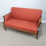 A 19thC upholstered mahogany show frame Sofa, raised on turned legs with brass casters, W 143cm x