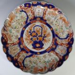 A pair of Japanese imari porcelain Chargers, with lobed rims, decorated in the traditional palate