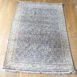 Tribal rugs; a mid 20thC Kashmir fine hand-knotted silk rug, all-over Paisley (boteh) design on
