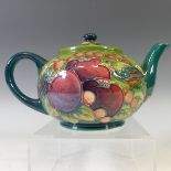 A Moorcroft 'Finch' pattern Teapot, with tubelined decoration on green ground, factory marks to