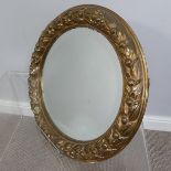 A heavy French style gilded brass circular wall Mirror, with leaf and berry border, 45cm Diameter.