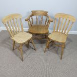 A beech bow-back Smokers Armchair, 62cm wide, together with a pair of kitchen chairs (3)