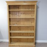 A 20thC pine Open Bookcase, with moulded cornice above five shelves raised on a plinth base, W 127cm