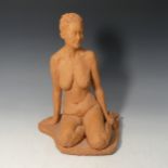 A Studio pottery terracotta female nude by Paul Redvers, ex Honiton pottery, depicting a female in