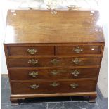 A Georgian mahogany Bureau, the fall front enclosing a fitted interior, above two short and three