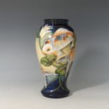 A Moorcroft 'Quiet Waters' pattern Baluster Vase, tube lined decoration on blue ground, with factory